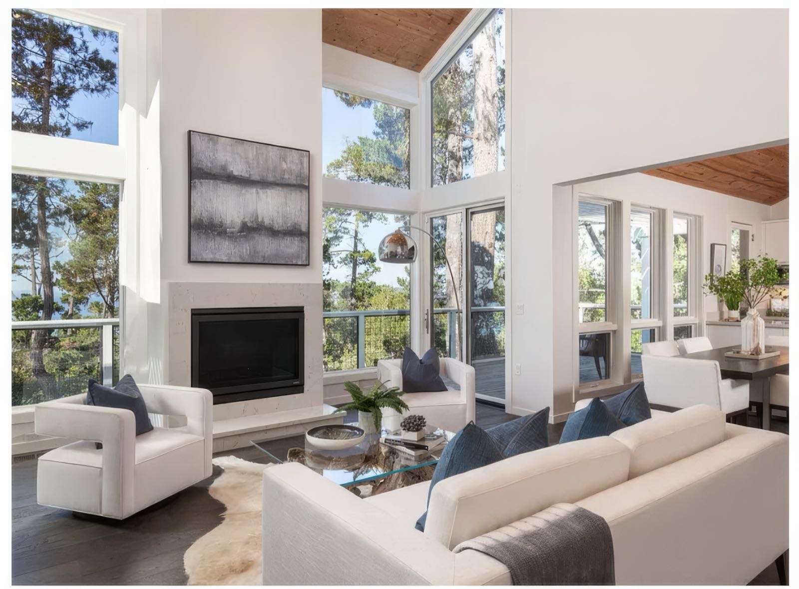 Living room from the opposite side, looking past the seating toward the dining table and the deck beyond.