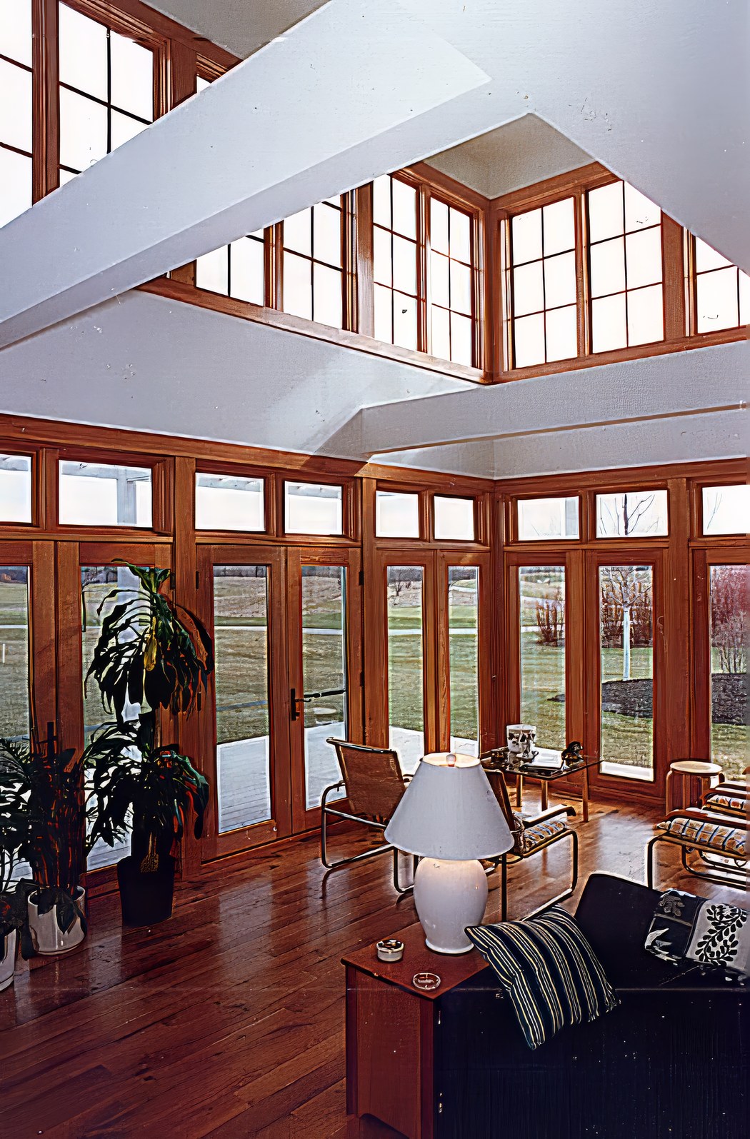 The living room looking up into the clerestory, where fir-framed windows run around all four sides above the roofs of the lower rooms.