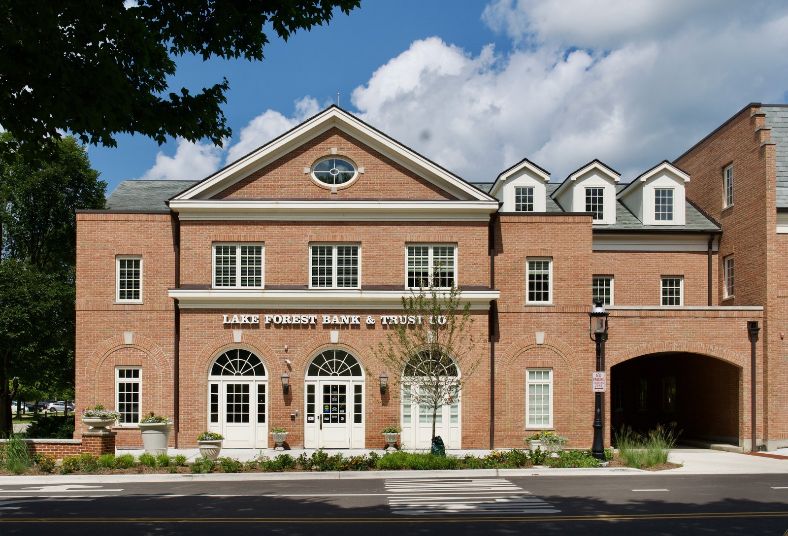 The pedimented centre block, with an oculus in the gable, three arched openings at ground level and dormers running off to the right.