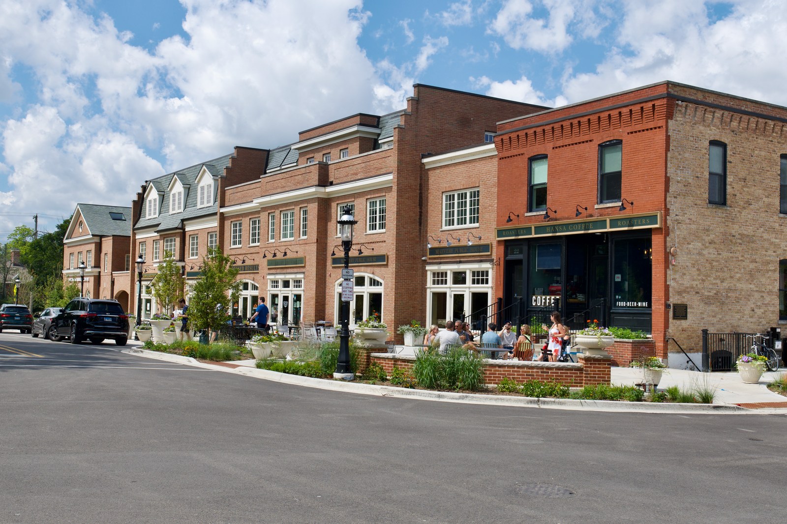 Looking along the street from the south-east, the new brick frontage running up to an older brick building at the corner.