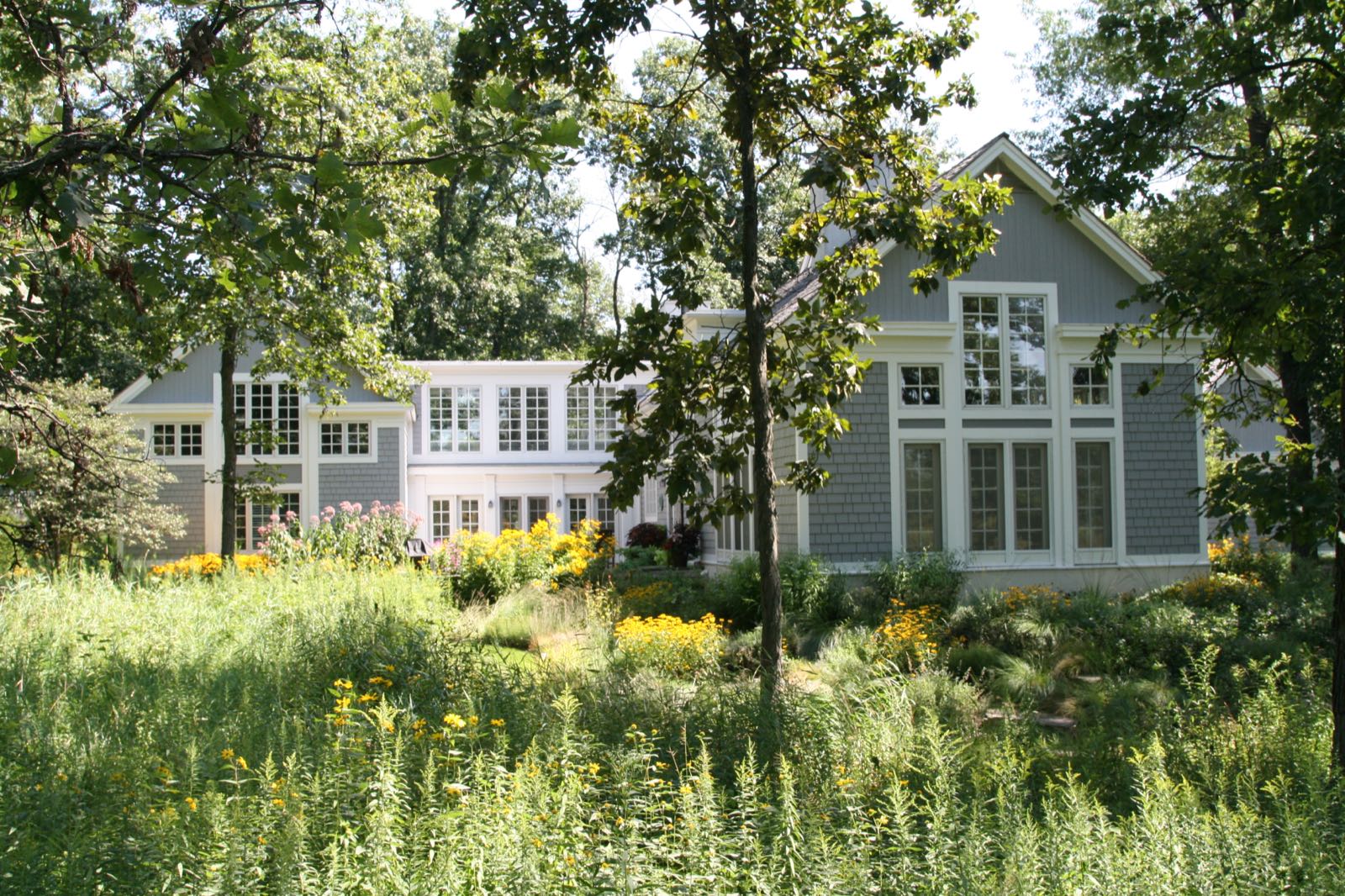The garden elevation, with terraces held between the wings of the house.