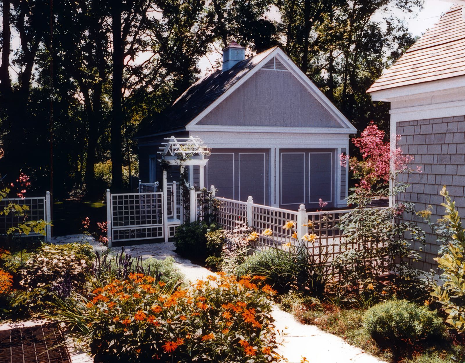 A planted terrace beside the house, enclosed by the surrounding wings.